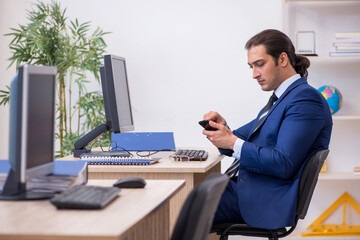 Young male employee working in the office