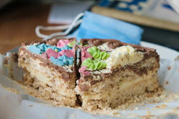 Cake with buttercream on a home background. Medical mask. Food orders concept.