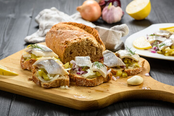 sandwiches with herring, onion and cucumber