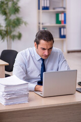Young male employee sitting in the office