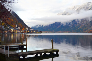 Hallstatt town view in a foggy day and clouds between the mountains. Amazing autumn cityscape, Austria, Salzkammergut region
