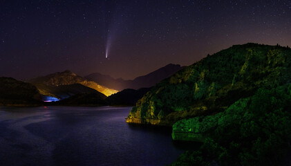 neowise comet over lake and mountains at night