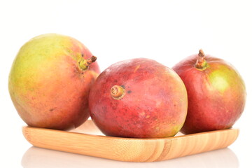 ripe organic mangoes, close-up, on a white background.