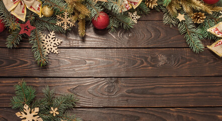 Fototapeta na wymiar fir branches with Christmas decor on old dark wooden background