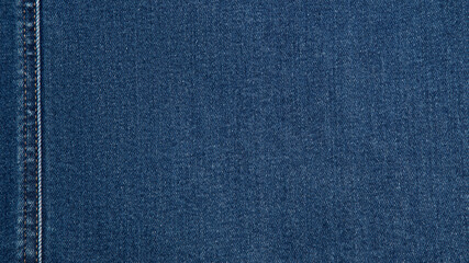 Blue background, denim jeans background. Jeans texture, fabric. Texture Jeans. Close Up Of Blue Jeans Fabric Macro With External Seams Yellow