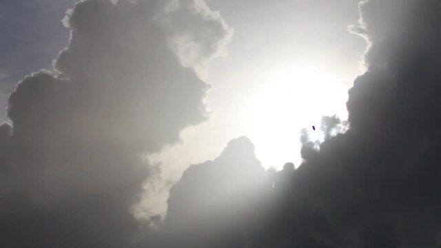 Low angle, sun shines through storm clouds in Tahiti