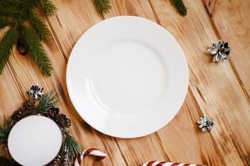 White plate Christmas mock up, New Year decorations, candles and tree