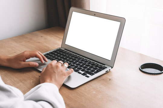 Blank Laptop Screen. A Woman Works Behind A Empty Laptop At A Desk.