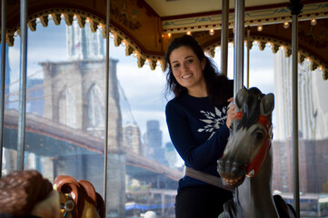 Woman riding a carousel in New York © Javier