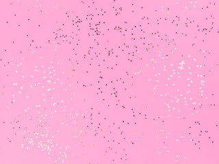 Confetti stars sparkling on a pink background.
