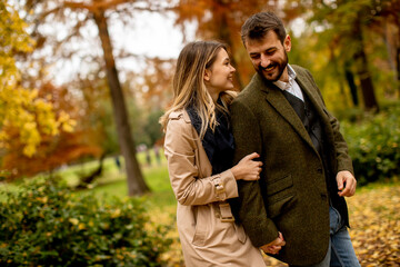 Young couple walking in the autumn park