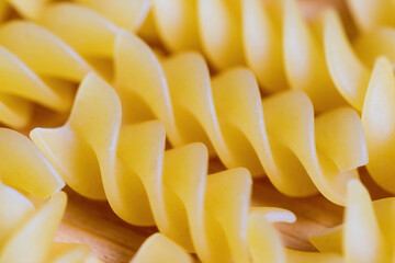 Closeup view of raw pasta on wooden background