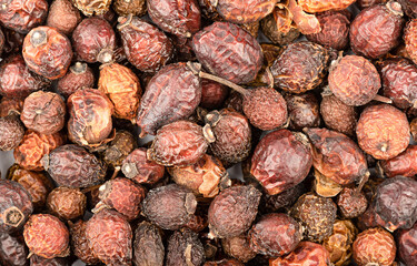 Full frame of dry rose hips as background, texture.