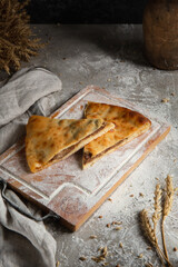 three cakes on wooden board and gray background