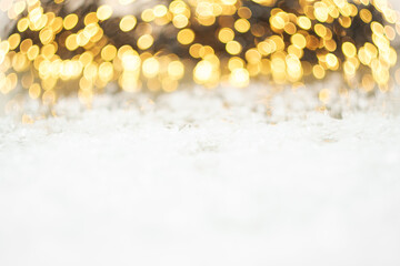Flickering bokeh of golden glitter lights and snow. Christmas background. New year party. 