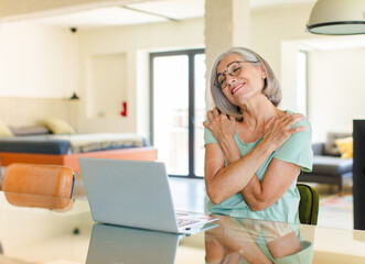 middle age woman feeling in love, smiling, cuddling and hugging self, staying single, being selfish and egocentric