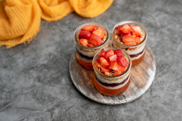 Yogurt with granola, decorated for fall with red and orange jelly and jello. Holiday glass jar dessert	
