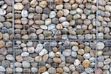 Stone wall. Stones in net. Big stones. Stone texture.