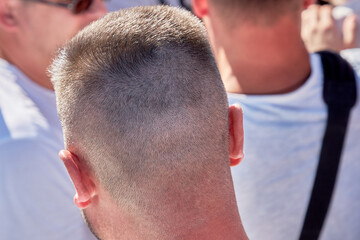 Fototapeta premium A young man standing among many people