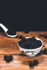 Blackberries on a wooden background. Blackberry. Summer small berry
