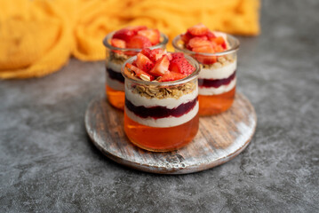 Yogurt with granola, decorated for fall with red and orange jelly and jello. Holiday glass jar dessert	
