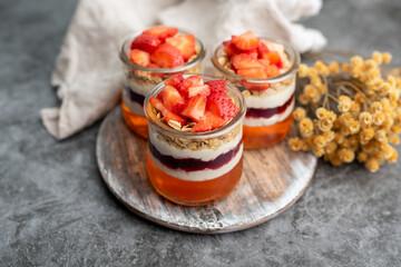 Yogurt with granola, decorated for fall with red and orange jelly and jello. Holiday glass jar dessert	