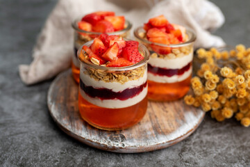 Yogurt with granola, decorated for fall with red and orange jelly and jello. Holiday glass jar dessert	