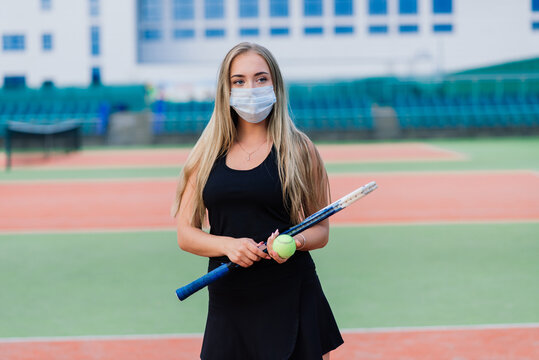 Female tennis player playing with protective mask