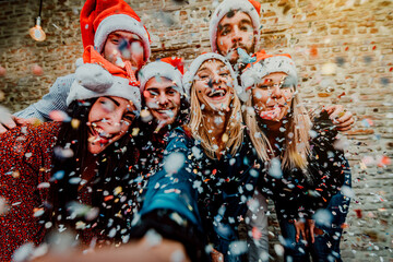 Group friends with santa hat celebrating Christmas time taking a selfie - Winter holiday concept...