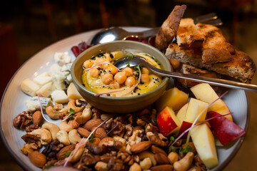 snack plate with roasted nut mix and chickpea hummus