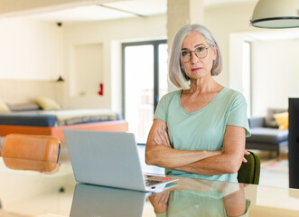 middle age woman feeling displeased and disappointed, looking serious, annoyed and angry with...