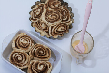 Baking cinnabons. The cinnamon dough is in the baking dish.