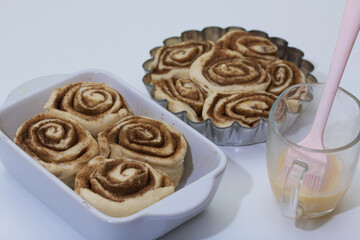 Baking cinnabons. The cinnamon dough is in the baking dish.