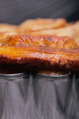 Baked cinnabons in shape. Stand on black composite boards. Close-up shot.
