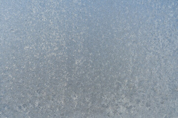 Frozen window glass covered with frost