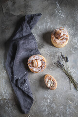 fresh baked goods in powdered sugar on wooden background