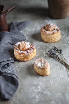 fresh baked goods in powdered sugar on wooden background