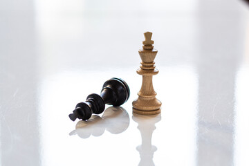 Downed Black King and Standing White King Chess Pieces