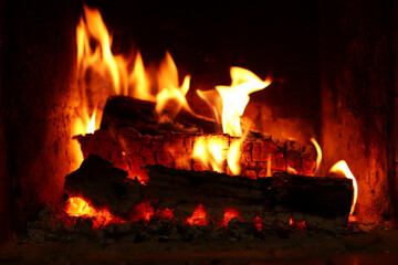 Wood is burning in the fireplace. Home comfort