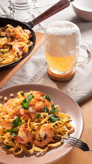 pasta with shrimps and beer in a glass