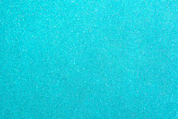 Fototapeta na wymiar Abstract glitter blurred shiny blue aqua background. Bright sparkling bokeh wallpaper style. Festive Christmas holiday futuristic texture.