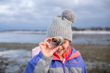 Girl with seashell in winter