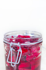 Fermented red cabbage lies in a glass jar. Sauerkraut with spices. Copy space.