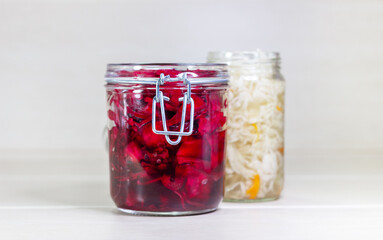 Sauerkraut and red cabbage on a wooden background. Fermented foods.