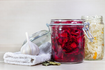 Homemade Sauerkraut with Carrot and Salad Cabbage with Beetroot on a wooden table. Fermented food.