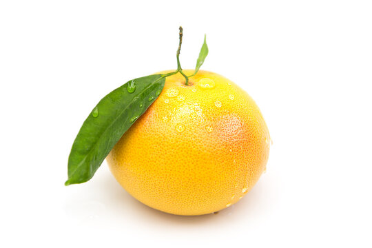 Ripe fresh grapefruit in dew drops isolated on white background
