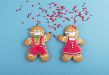 Gingerbread man with a mask on his face on a blue background