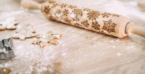 rolling pin with flour lies on a wooden table