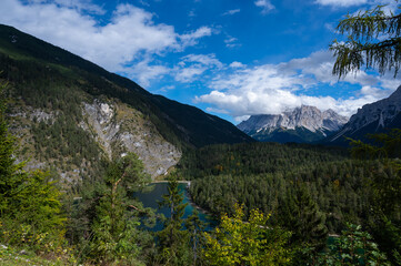 Panoramic view from the Rest Area "Zugspitzblick" at the Fernpass alpine road to the Zugspitze Mountain and Lake Blindsee, in Ausrria. Beautiful mountain scenery in Alps.
