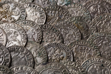 Closeup view of medieval European silver coins.Zygmunt III Waza.Ancient silver coins.Numismatics.silver coins covered in dirt.Antikvariat.